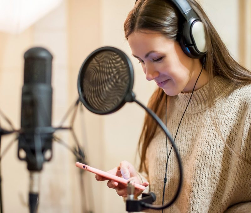 young-girl-singer-recording-vocals-in-professional-recording-studio-close-up.jpg